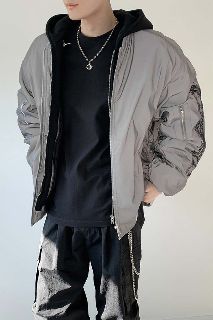 Black TM3 bomber jacket featuring grey fabric, black dragon embroidery, and reflective accents on the sleeves and chest.