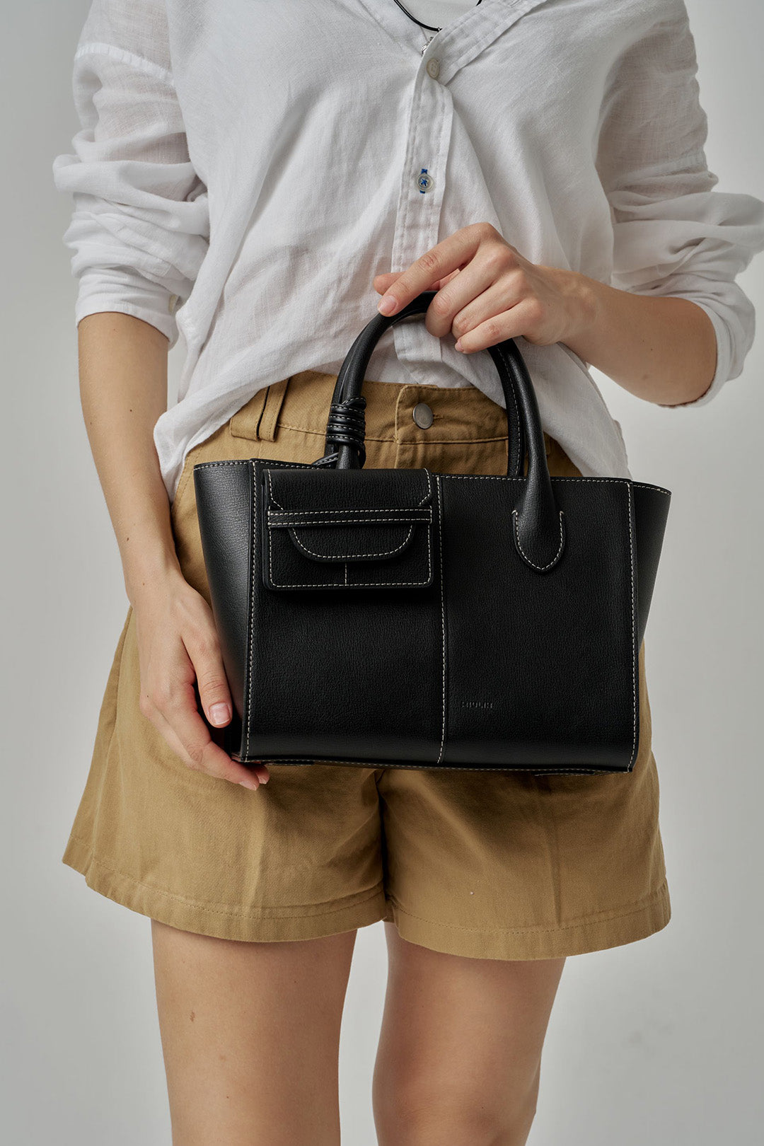 Black MIULIN 1st Anniversary Edition wallet bag showing sleek design with compact size and minimalist style.