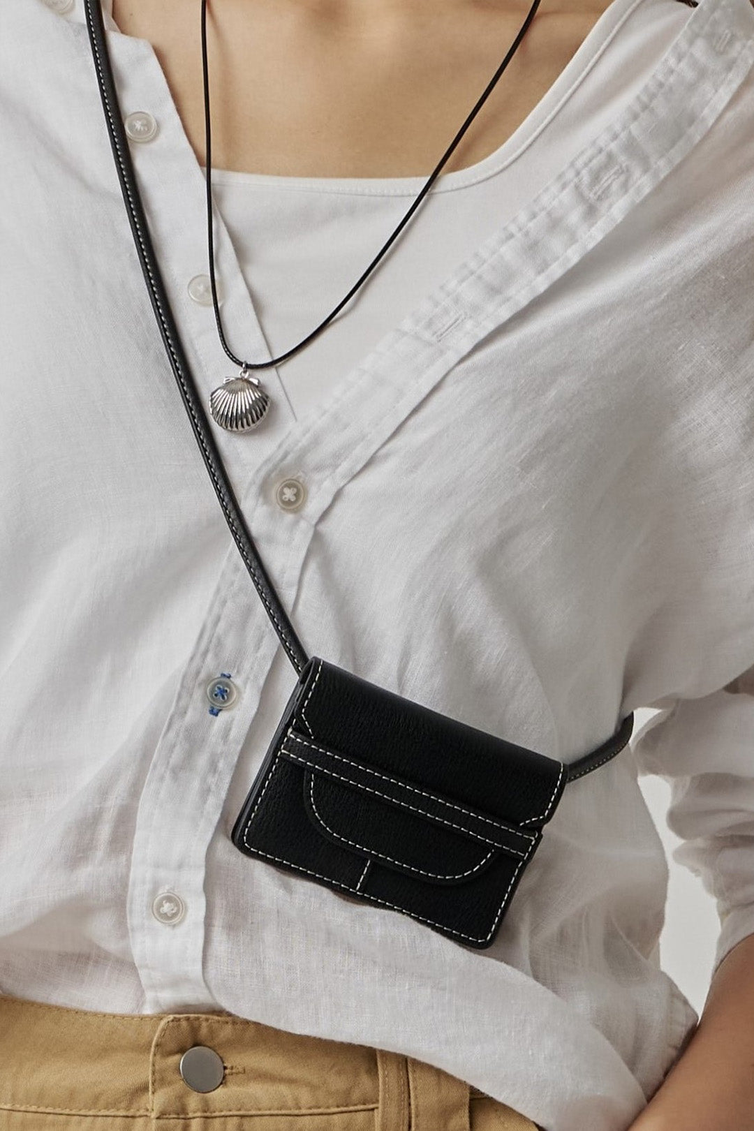Black MIULIN 1st Anniversary Edition wallet bag showing compact design with wallet compartments and stylish details.