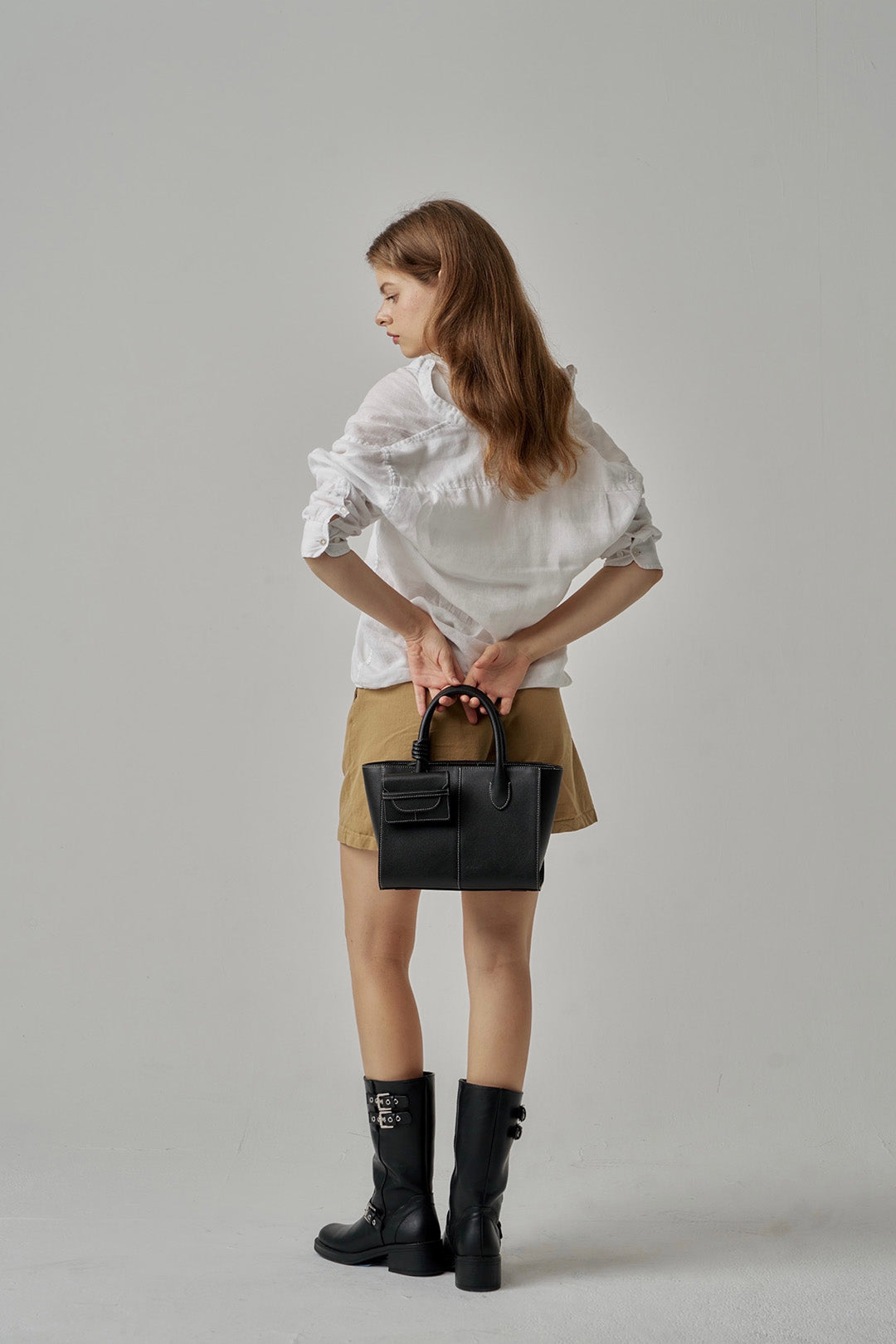 Black MIULIN 1st Anniversary Edition wallet bag showing sleek design with zipper closure and compact size.