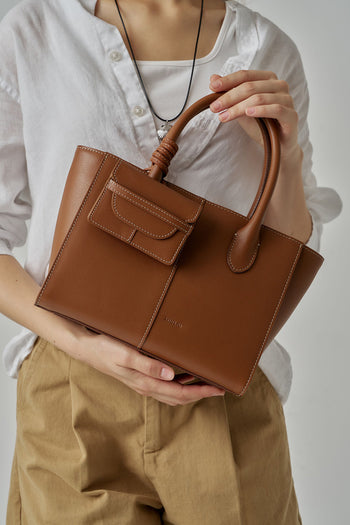 MIULIN 1st Anniversary Edition Camel Wallet Bag showing its compact design with a sleek strap and textured leather finish.
