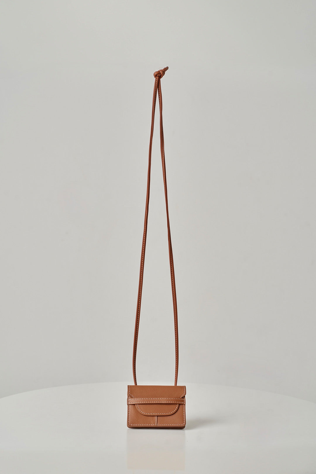 MIULIN 1st Anniversary Edition Wallet Bag in camel leather with sleek design and compact size for everyday use.