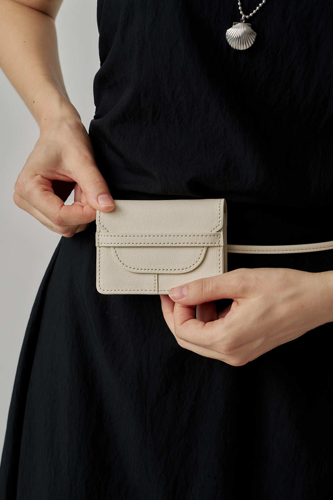 Ivory MIULIN 1st Anniversary Edition wallet bag with sleek design, compact size, and elegant details displayed in the image.