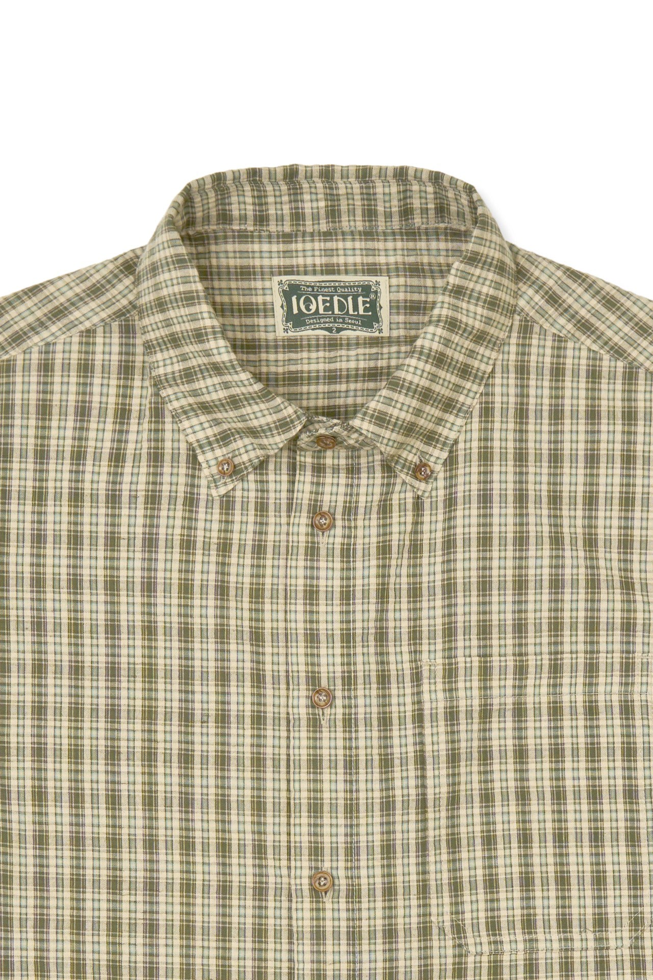 IOEDLE Rocket Slit Short-sleeve Shirt with stylish design and slit detail, displayed hanging on a wooden hanger.
