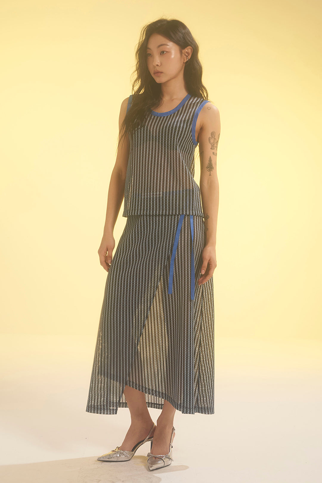 Blue striped mesh tank top by LOVE CRAZY WILD MAN, featuring sleeveless design and lightweight breathable fabric.