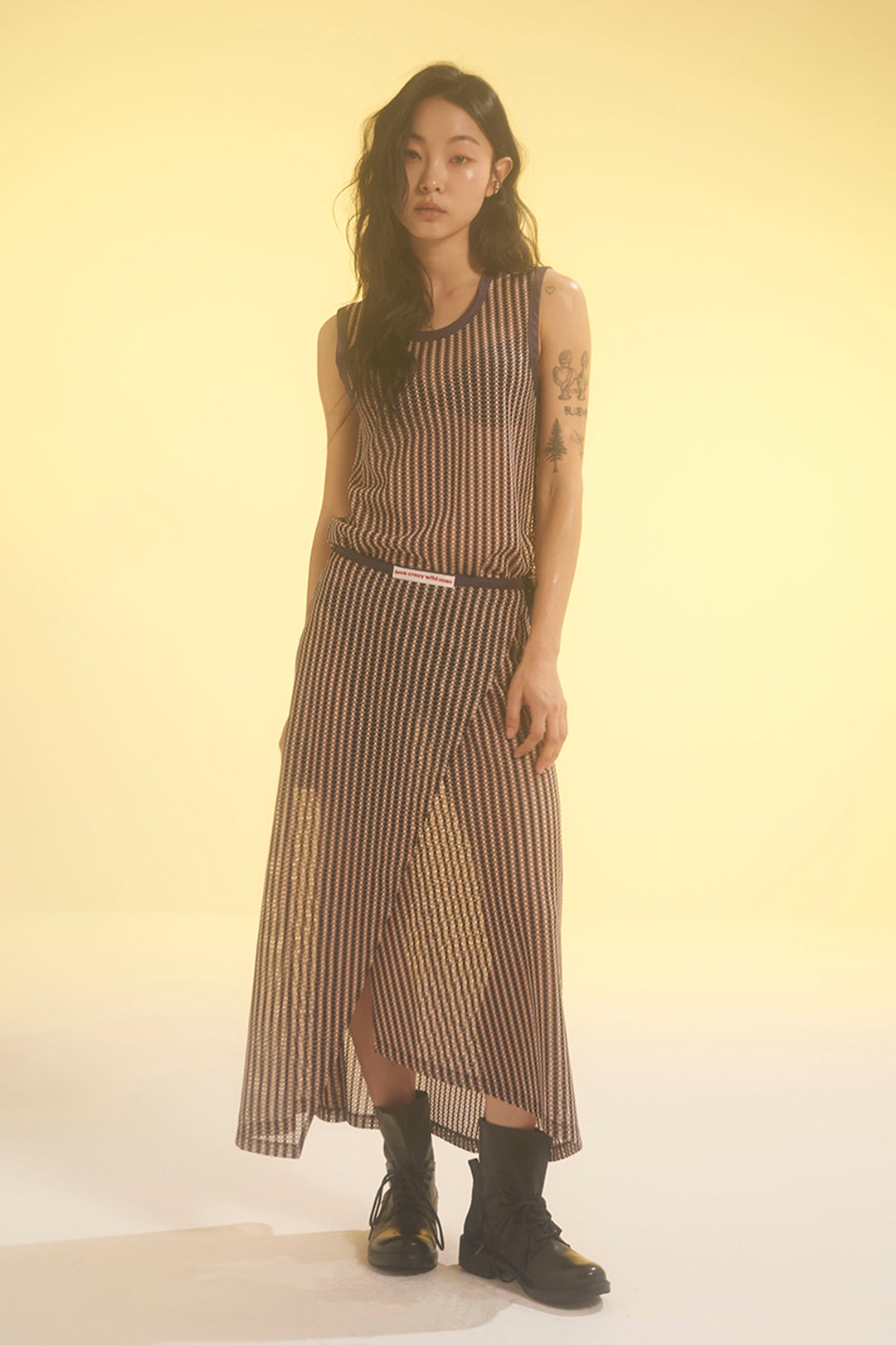 Beige stripe mesh tank top by LOVE CRAZY WILD MAN, featuring breathable fabric and sleeveless design for casual wear.