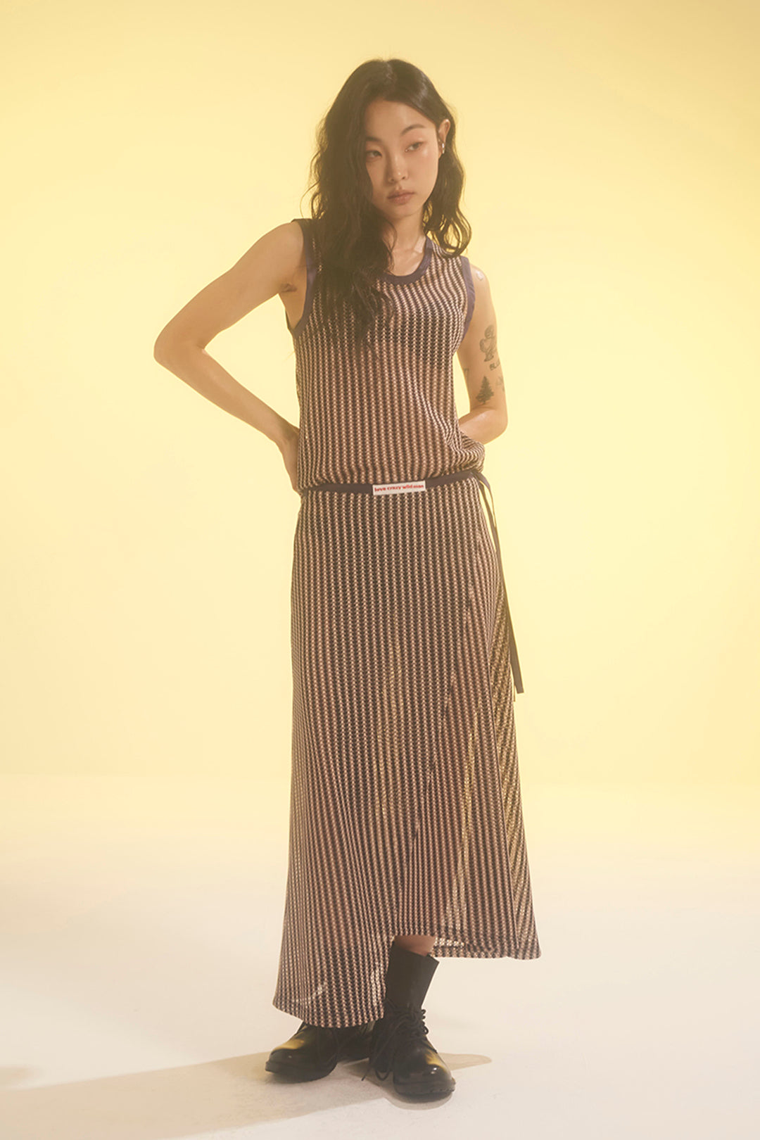 Beige striped mesh wrap skirt by LOVE CRAZY WILD MAN, featuring a lightweight, semi-transparent design and adjustable tie at the waist.