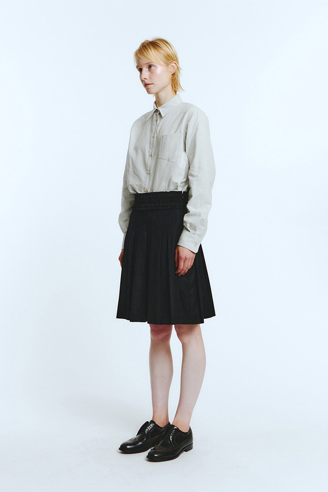 Black frill pleats skirt from LOVE CRAZY WILD MAN with a flowy, layered design and ruffled hem, shown on a mannequin.