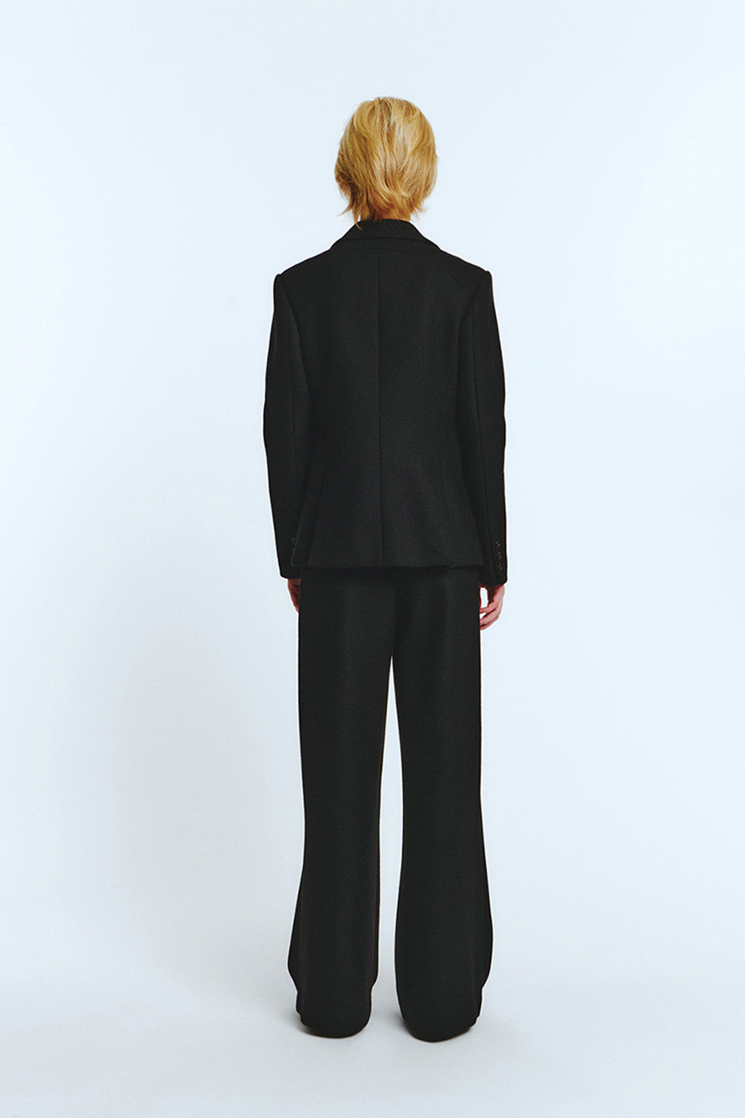 Black blazer jacket by LOVE CRAZY WILD MAN, tailored fit with lapels, shown on a hanger against a neutral background.