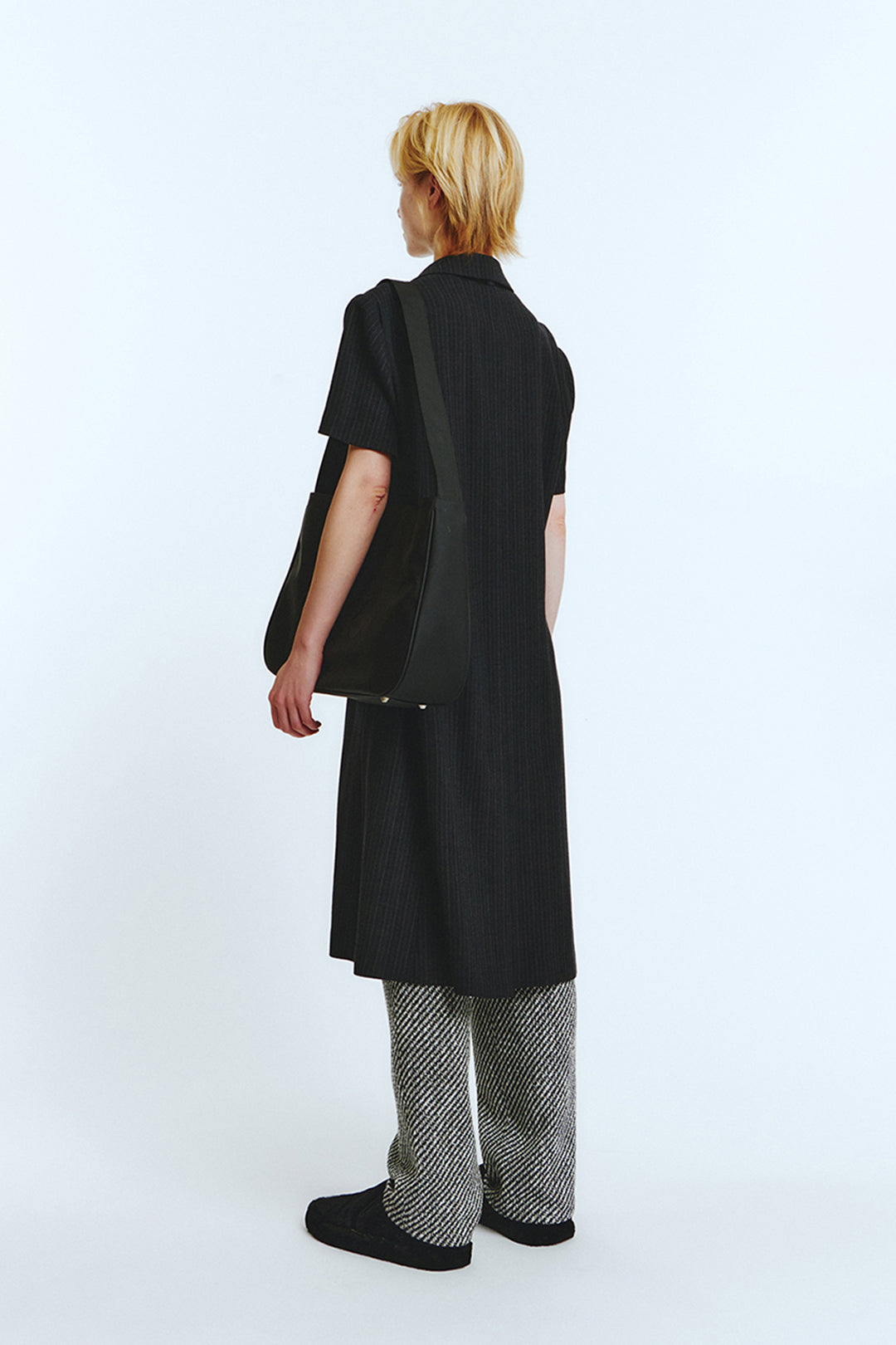 Black half sleeve coat by LOVE CRAZY WILD MAN, showcasing a stylish, modern design with a tailored fit and sleek fabric.