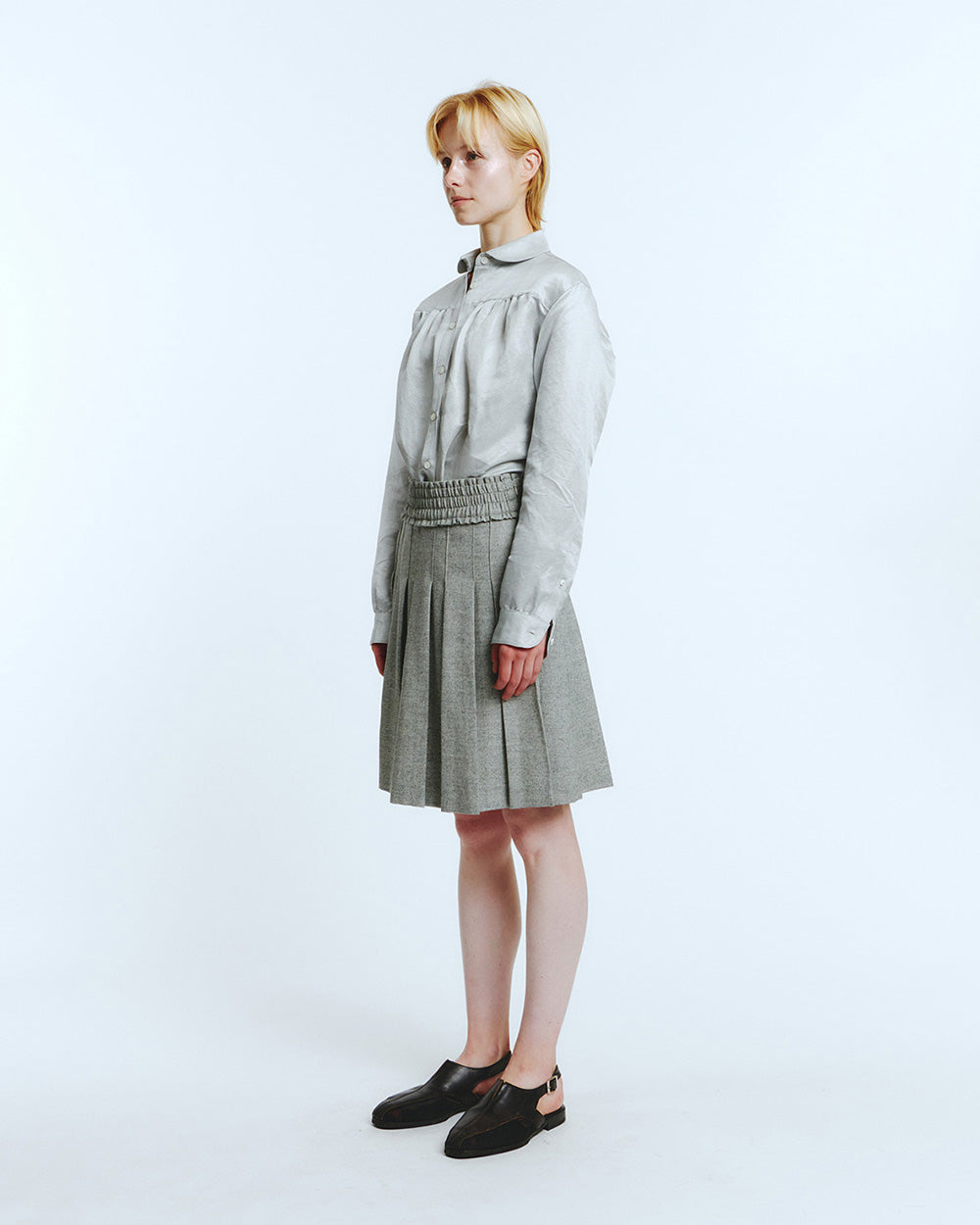 LOVE CRAZY WILD MAN Frill Pleats Skirt in Melange Grey, showcasing soft pleated fabric and feminine frill details.