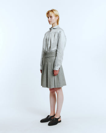 LOVE CRAZY WILD MAN Frill Pleats Skirt in Melange Grey, showcasing soft pleated fabric and feminine frill details.