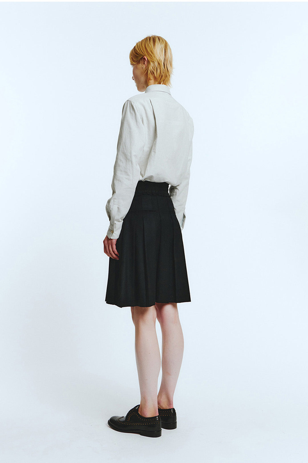 Black frill pleats skirt by LOVE CRAZY WILD MAN, showcasing flowy fabric and layered ruffle details.