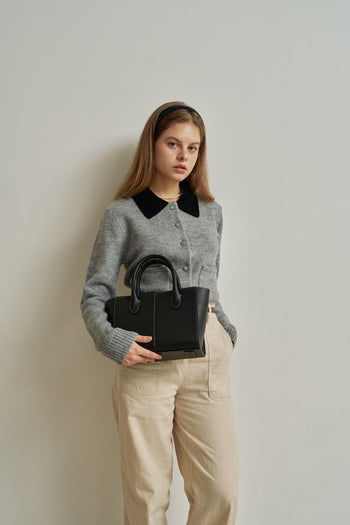 Medium Blenged leather tote bag by MIULIN with sturdy handles and sleek design, shown in a natural outdoor setting.