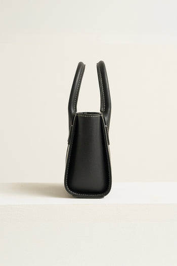 Medium MIULIN Blenged leather tote bag with sturdy handles and sleek design, shown in a natural outdoor setting.