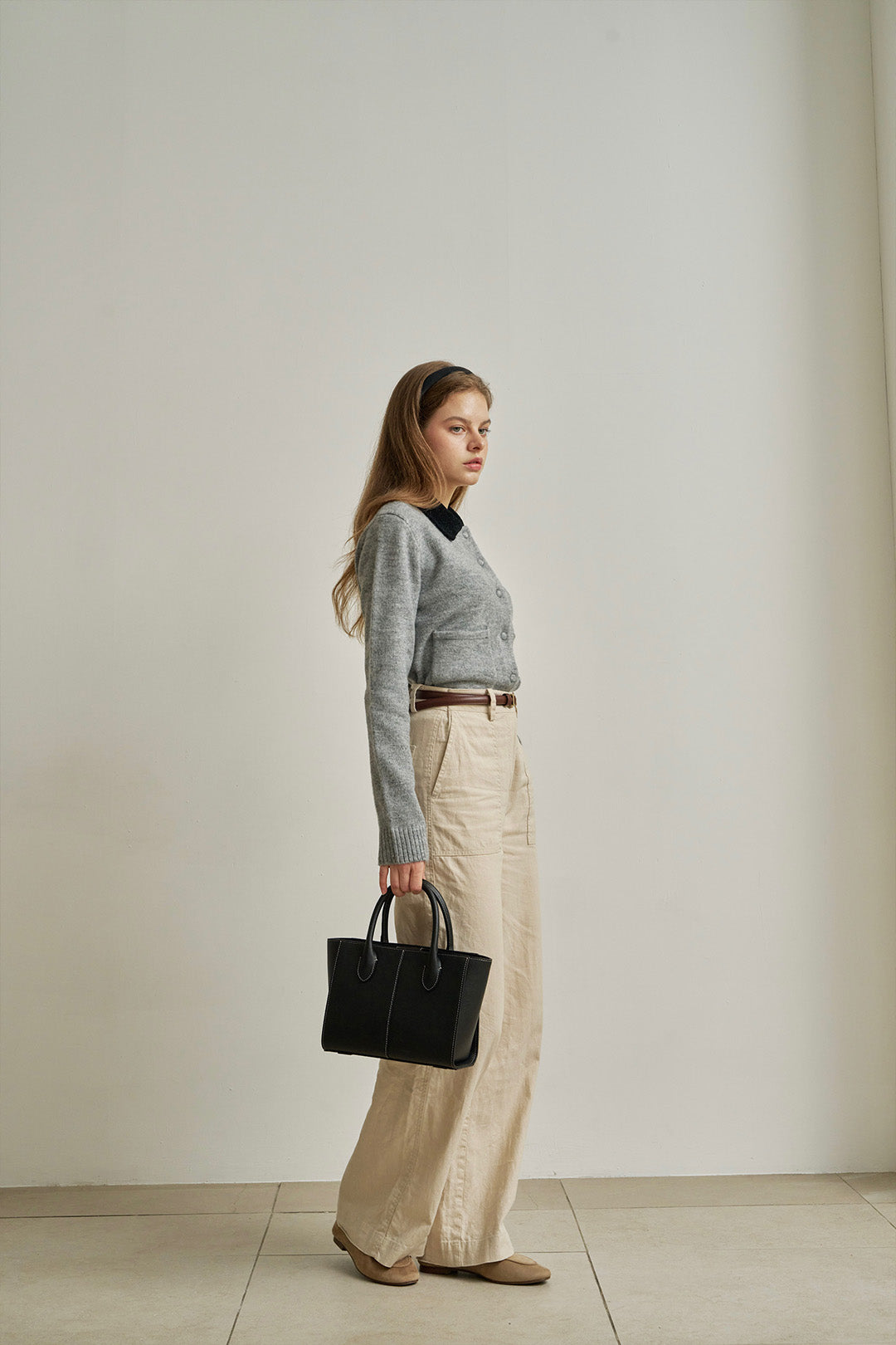 Medium Blenged leather tote bag by MIULIN with sturdy handles and sleek design, shown in natural light highlighting its texture and craftsmanship.