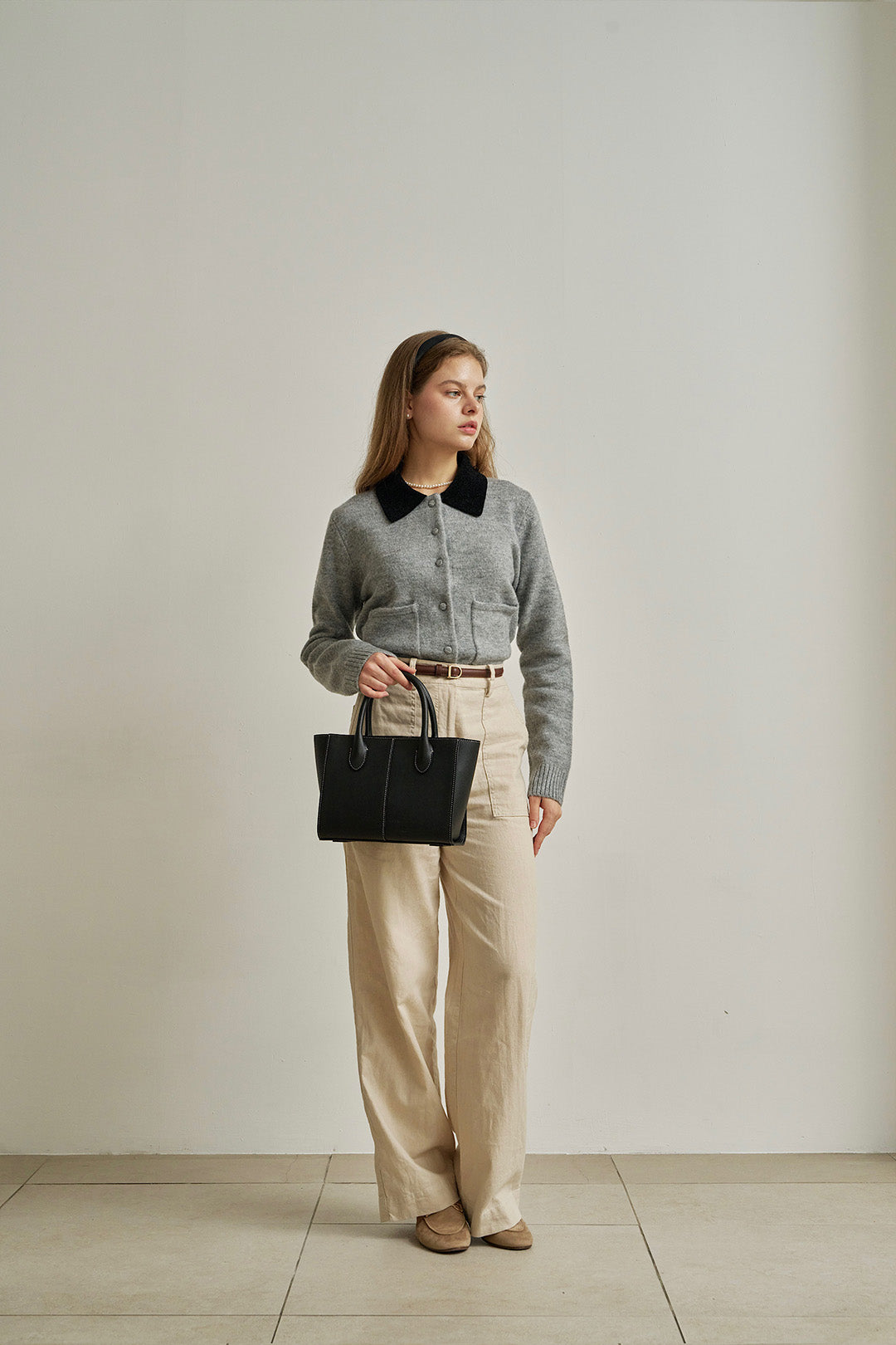 Medium MIULIN Blenged leather tote bag with sturdy handles and sleek design, shown in a natural outdoor setting.