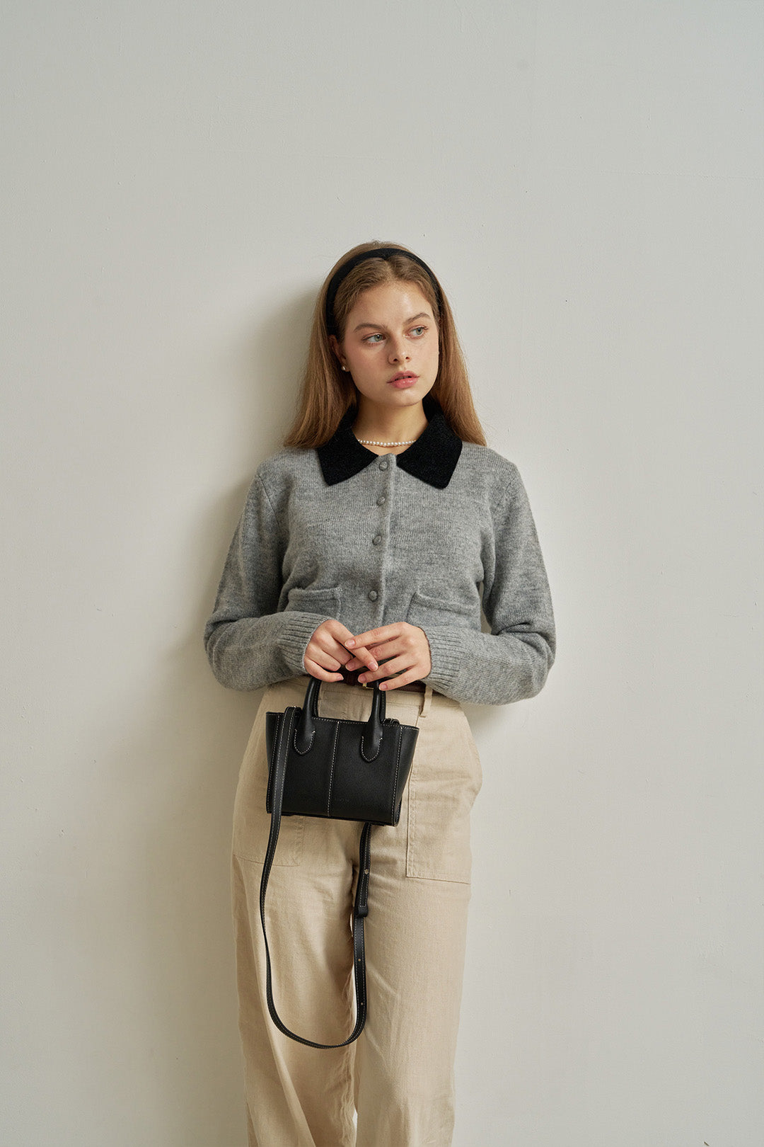 Small MIULIN Blenged leather bag with top handles and sleek design, ideal for everyday use.
