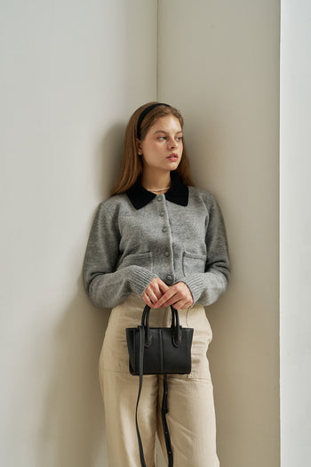 Small MIULIN Blenged leather bag with top handles and minimalist design, showcasing smooth leather and elegant craftsmanship.