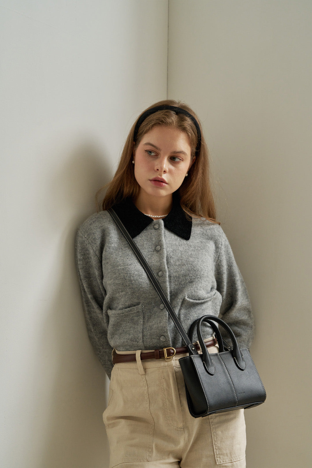 Small Blenged leather bag by MIULIN featuring a sleek design with top handles and a compact, stylish silhouette.