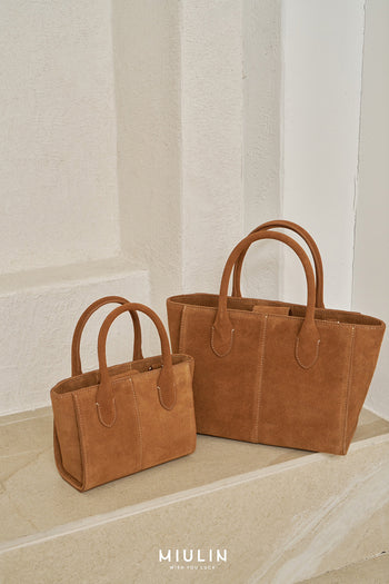 Medium Brunir suede tote bag by MIULIN with dual shoulder straps and minimalist design, shown in a natural tan color.