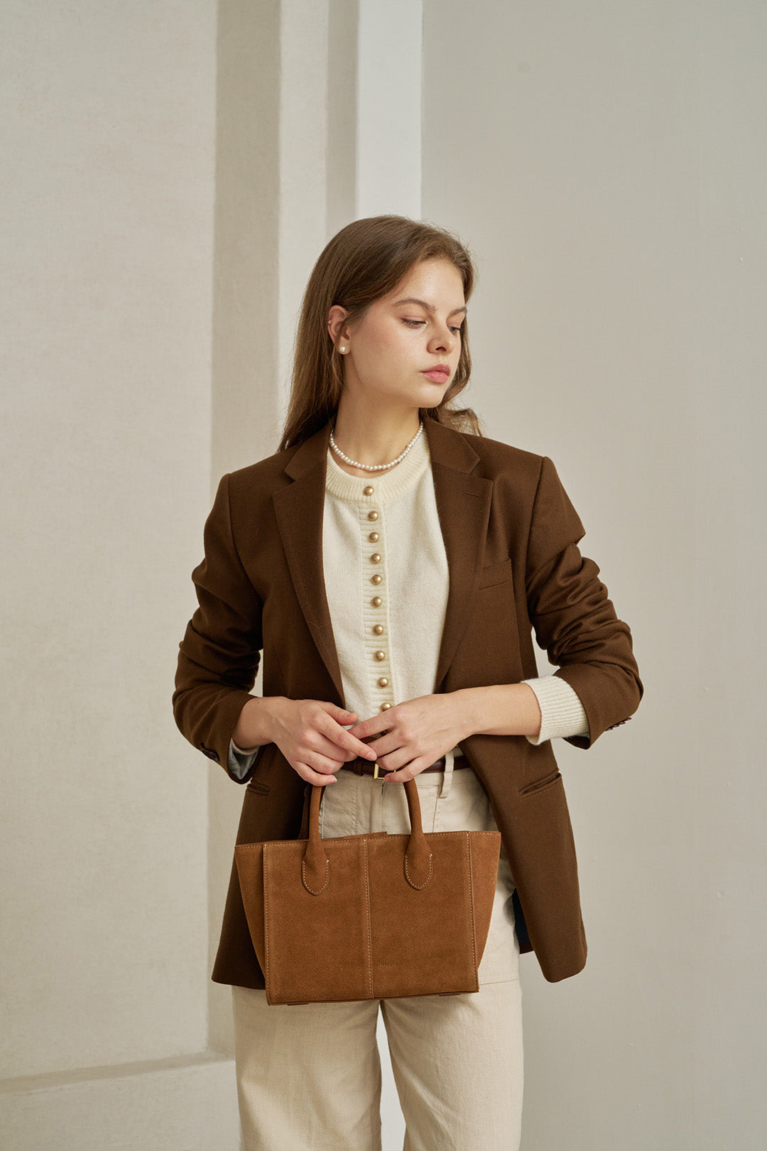 Medium Brunir suede tote bag by MIULIN with double handles and minimalist design, shown in a natural tan color.
