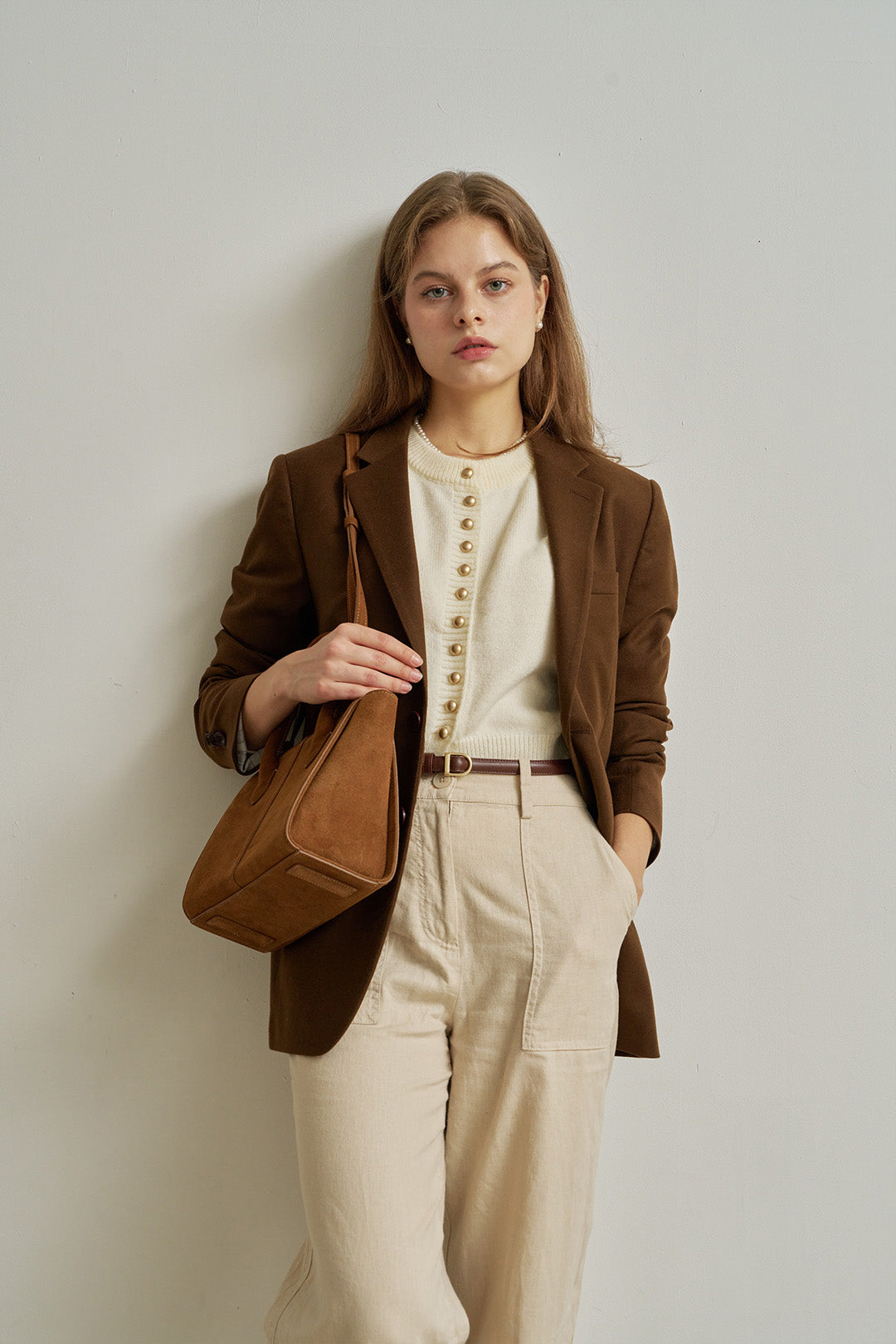 Medium Brunir suede bag by MIULIN with top handle and spacious interior, shown with a natural suede texture and minimalist design.