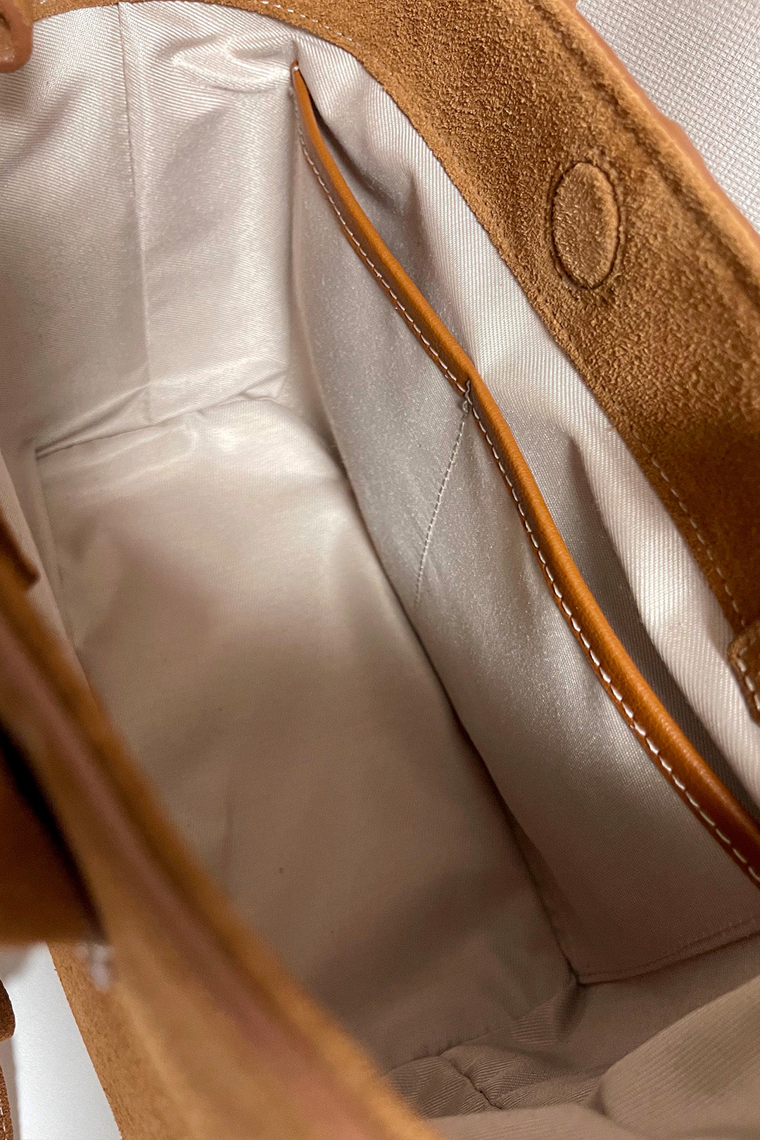 Medium Brunir suede tote bag by MIULIN with double handles and sleek design, shown in a natural suede texture.