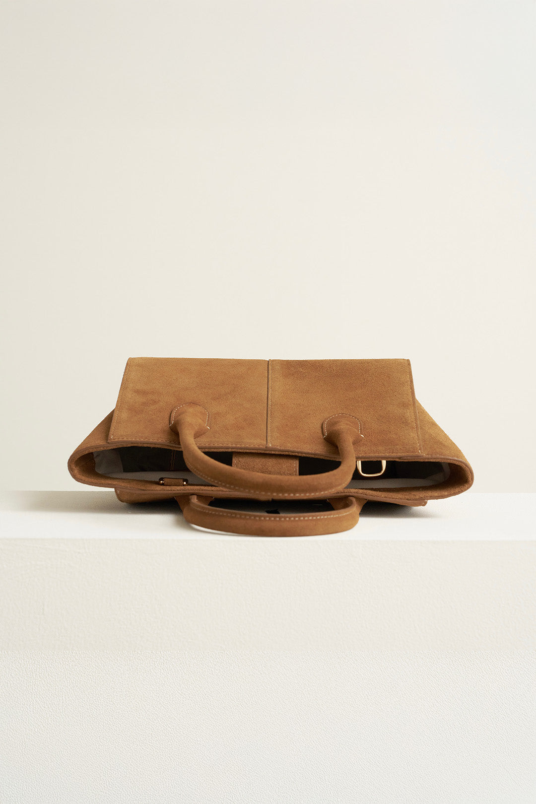 Medium MIULIN Brunir suede bag with top handles and spacious interior, showcasing its soft textured surface and stylish design.