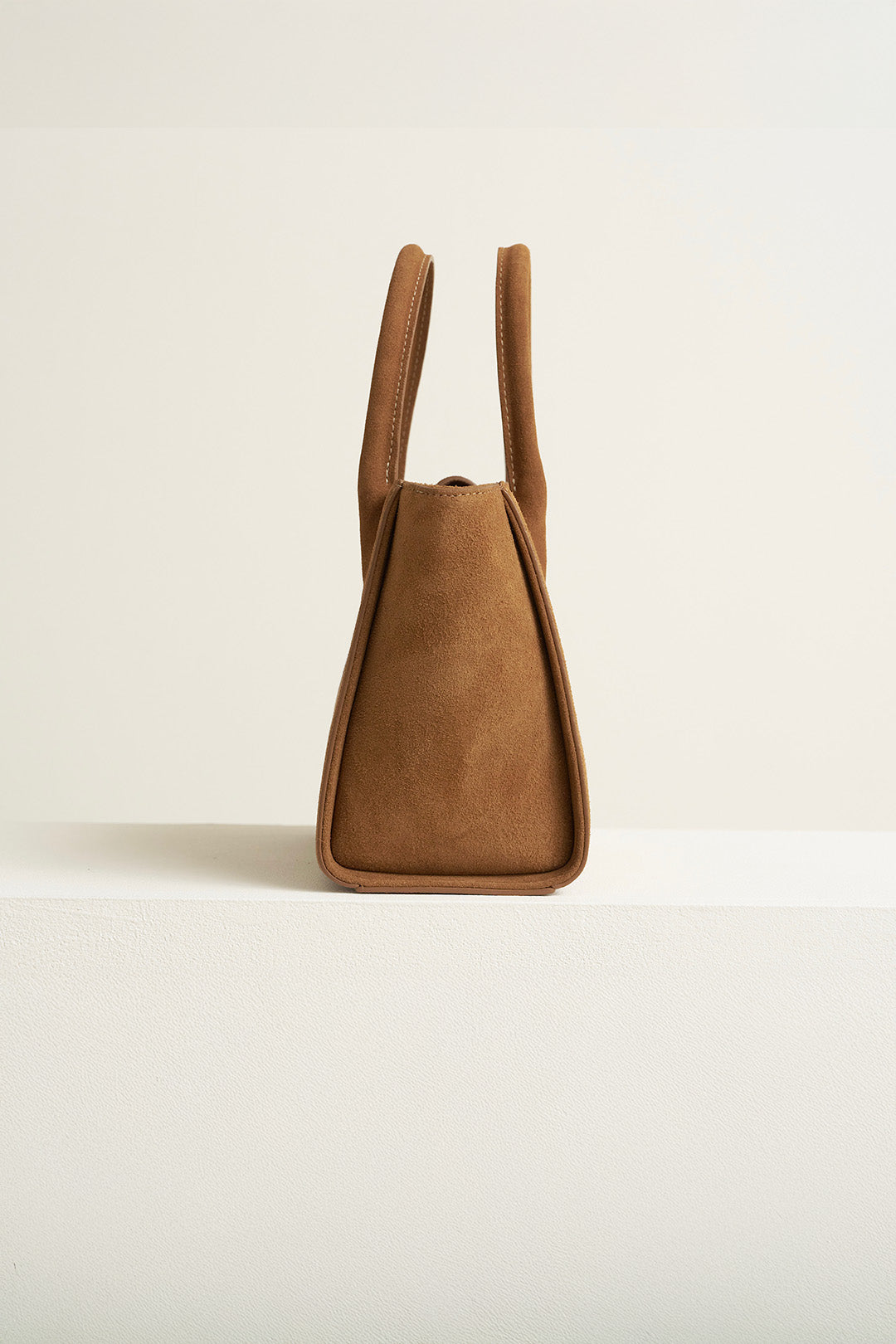Medium Brunir suede tote bag by MIULIN with sturdy handles and smooth suede texture, perfect for everyday use.