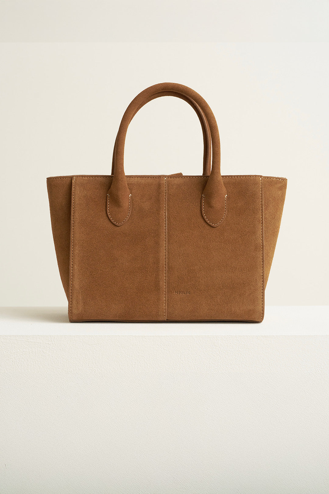 Medium Brunir suede tote bag by MIULIN with top handles and spacious interior, showcasing soft texture and stylish design.