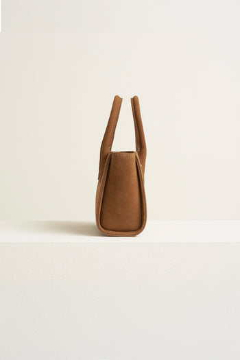 Small MIULIN Brunir suede tote bag with top handles and minimalist design, showcasing soft brown suede material.