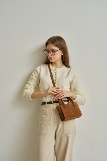 Small MIULIN Brunir suede bag with top handles and minimalist design, showing its soft, textured suede material.