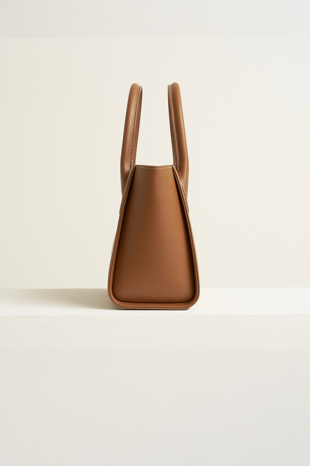 Medium Camille leather bag by MIULIN featuring sleek design and structured silhouette, shown in natural leather finish.