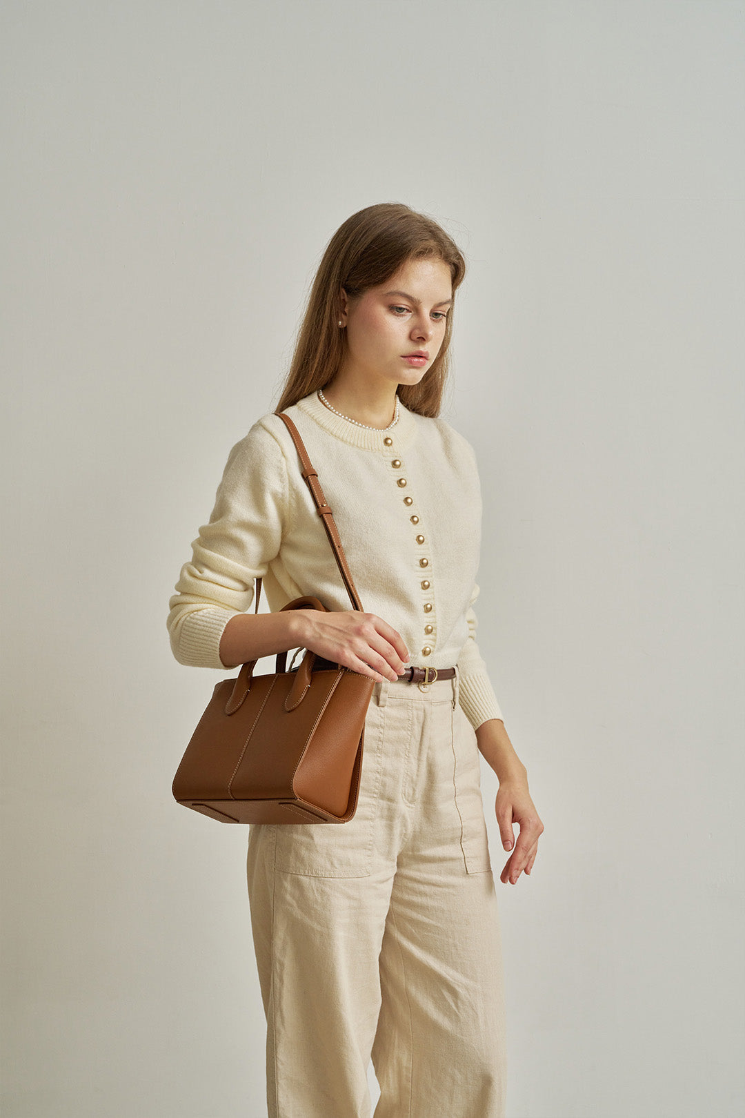 Medium Camille leather bag by MIULIN featuring a sleek, structured design with top handles and a smooth finish.