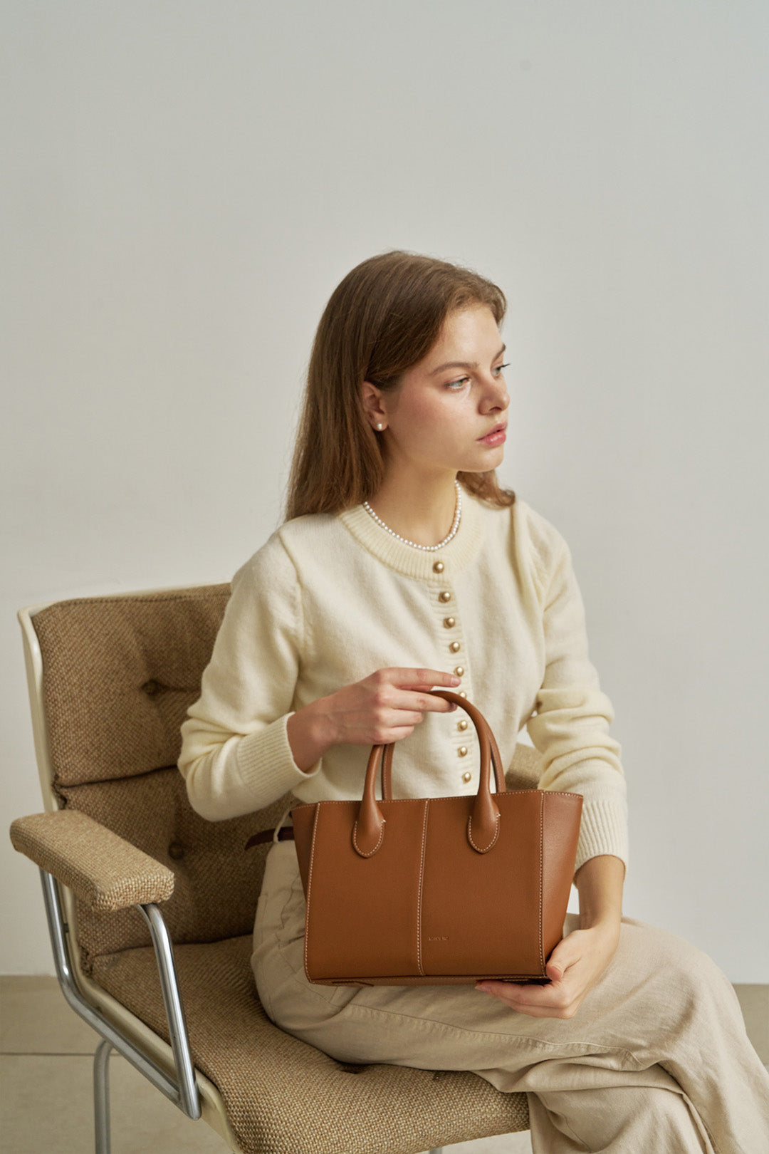 Medium Camille leather bag by MIULIN featuring a chic, structured design with top handles and sleek finish.