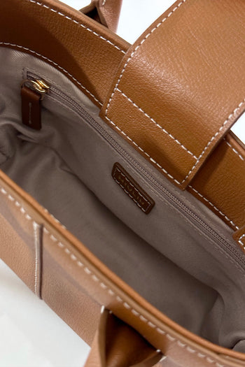 Small MIULIN Camille leather bag with top handles and minimalist design, showcasing its elegant texture and craftsmanship.