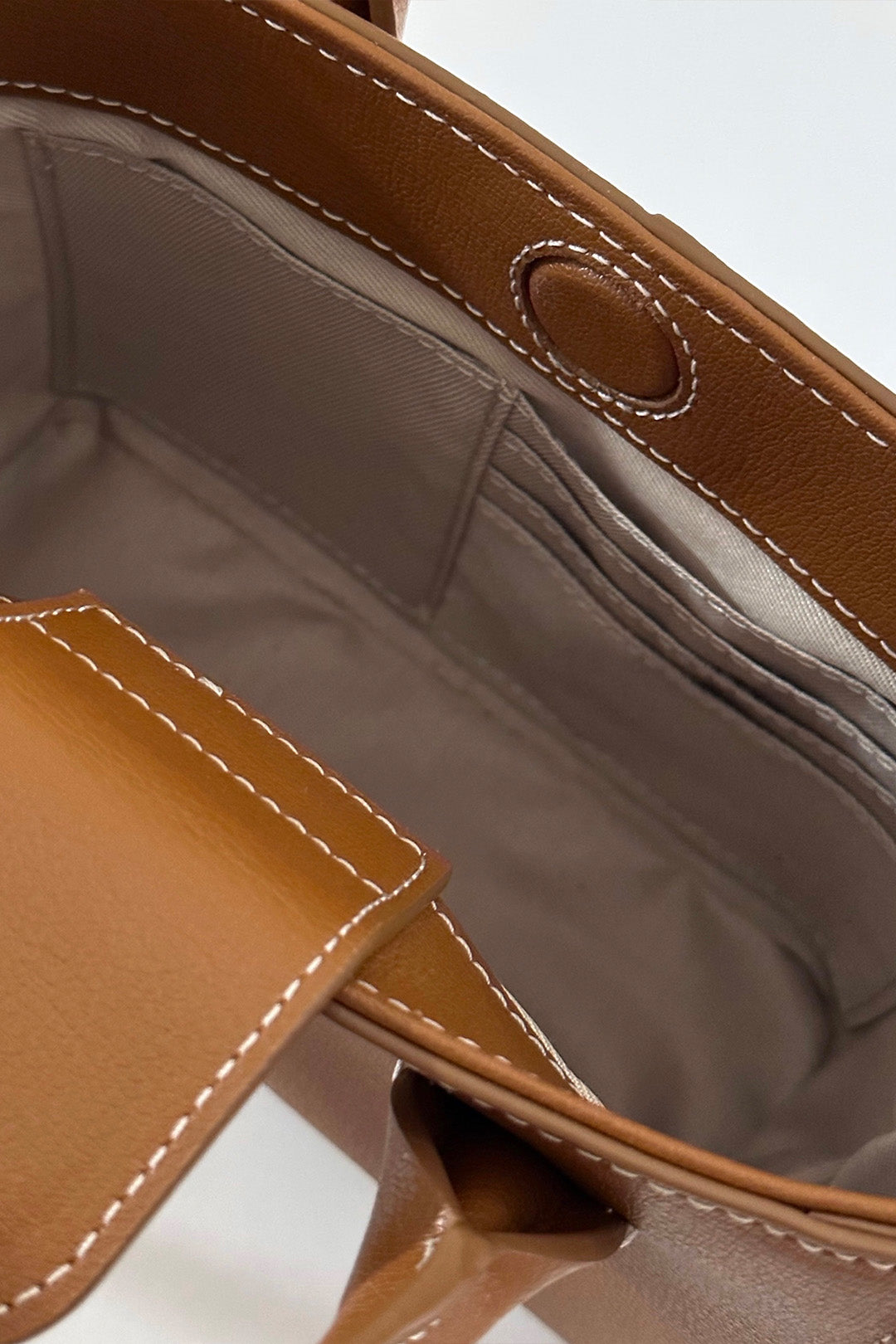Small MIULIN Camille leather bag with top handles and sleek design, shown from the front.