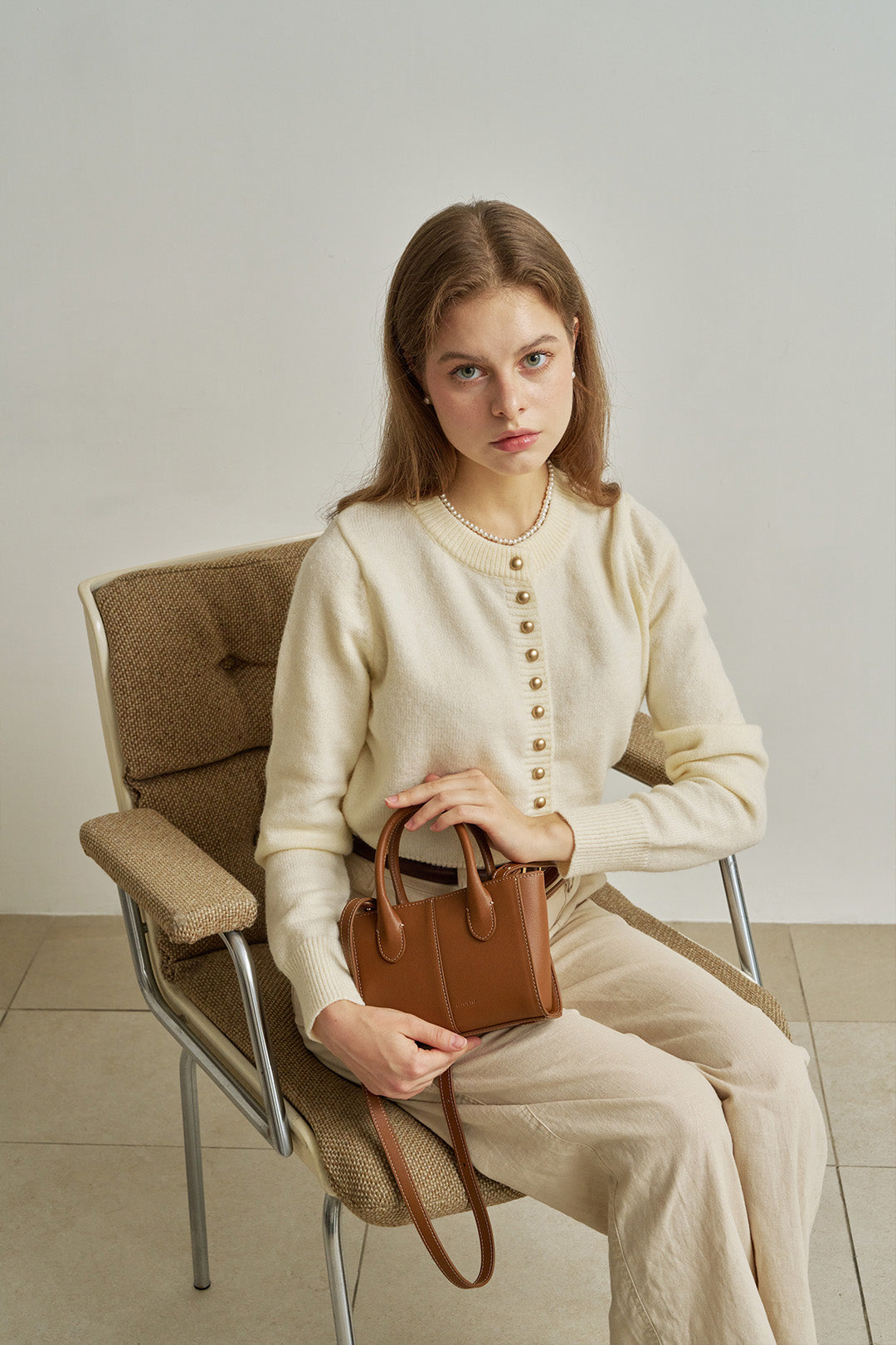 Small MIULIN Camille leather bag with double handles and sleek design, perfect for stylish everyday use.