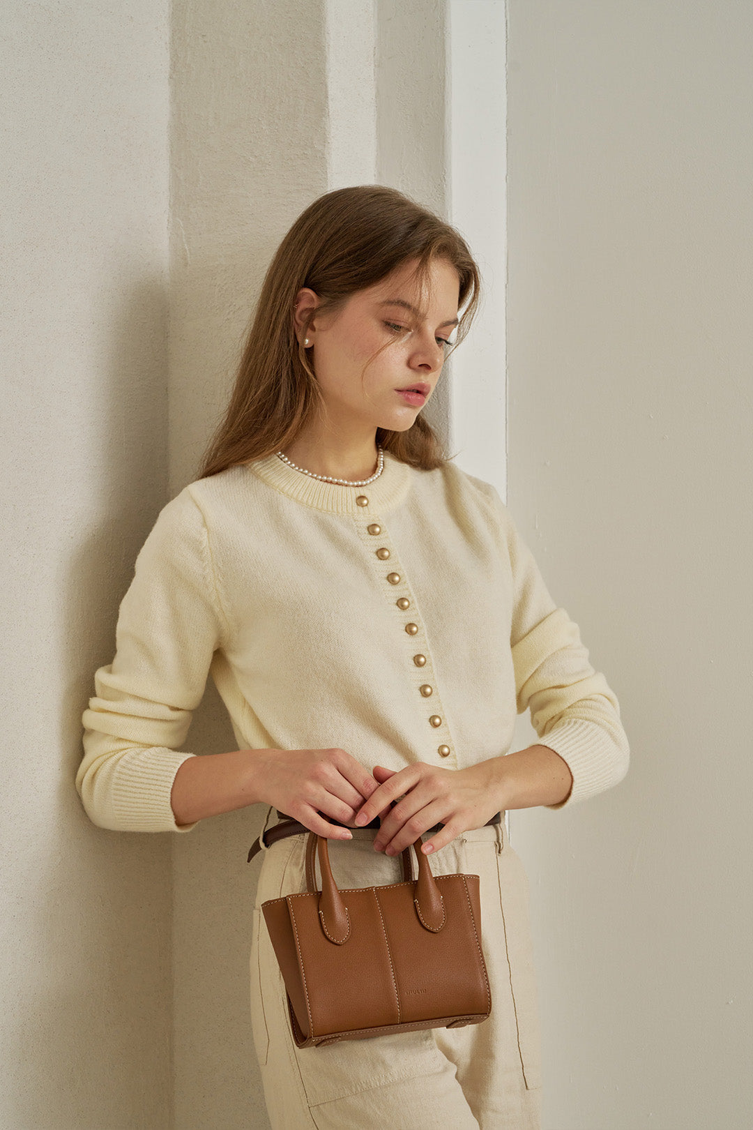 Small MIULIN Camille leather bag with top handle and sleek design, perfect for everyday use.