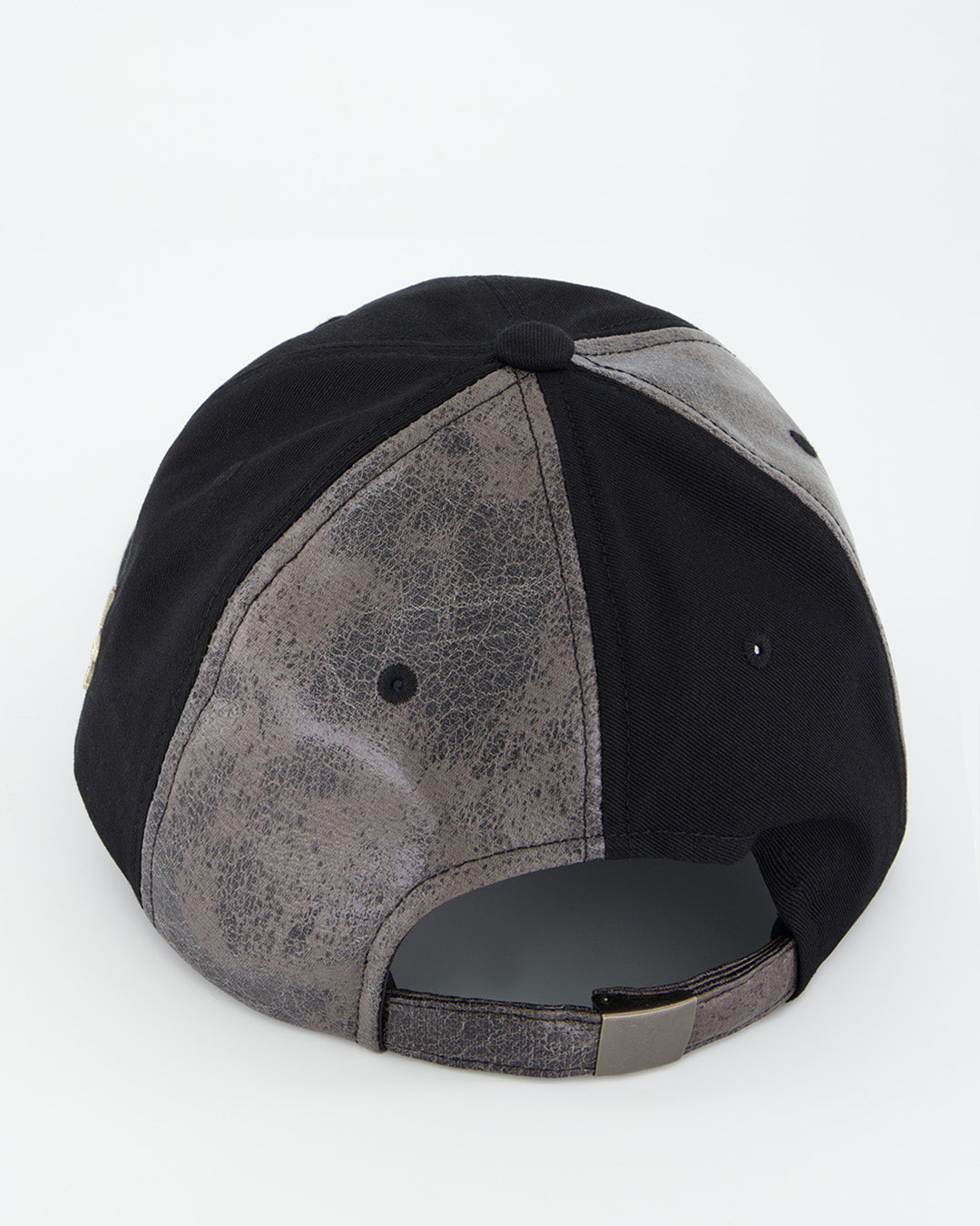 Black asymmetric raw creviced cap by KIMMICK, featuring a unique design with textured fabric and modern style.