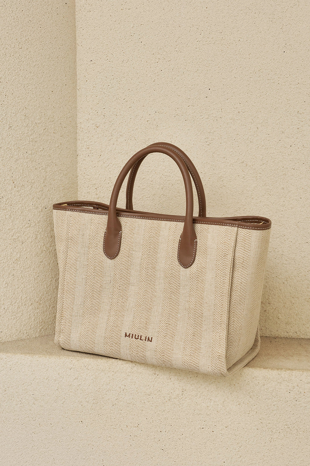 Large beige creamed canvas tote bag by MIULIN with sturdy handles and spacious interior for everyday use.