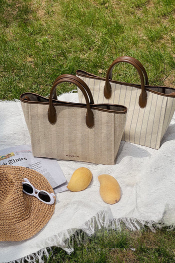 Large beige creamed canvas tote bag by MIULIN with sturdy handles and spacious interior for everyday use.