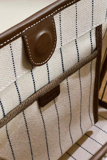 Large cream-colored canvas tote bag with blue and white striped pattern by MIULIN, featuring sturdy handles and spacious interior.