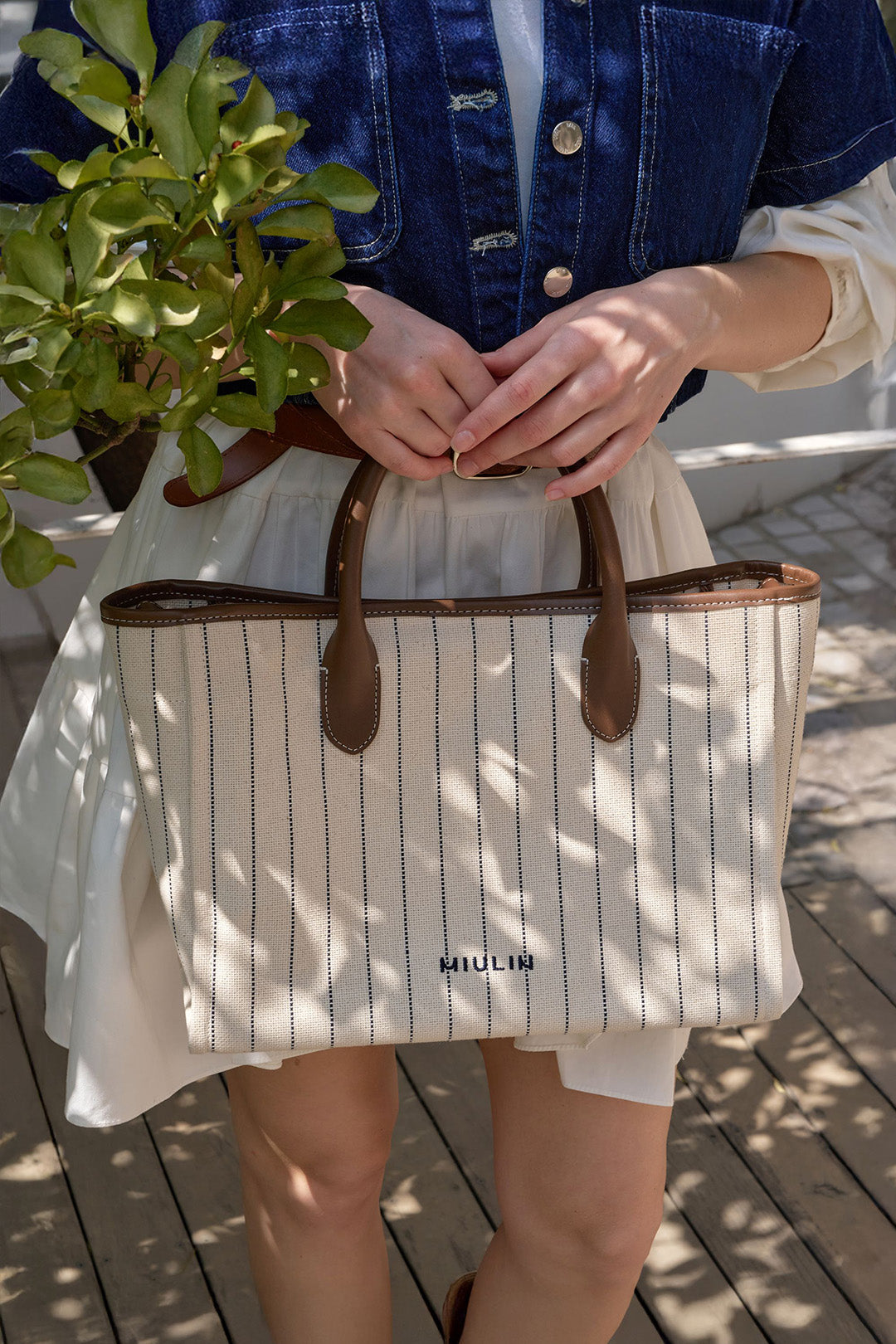Large striped cream canvas tote bag by MIULIN featuring sturdy handles and spacious interior for everyday use.