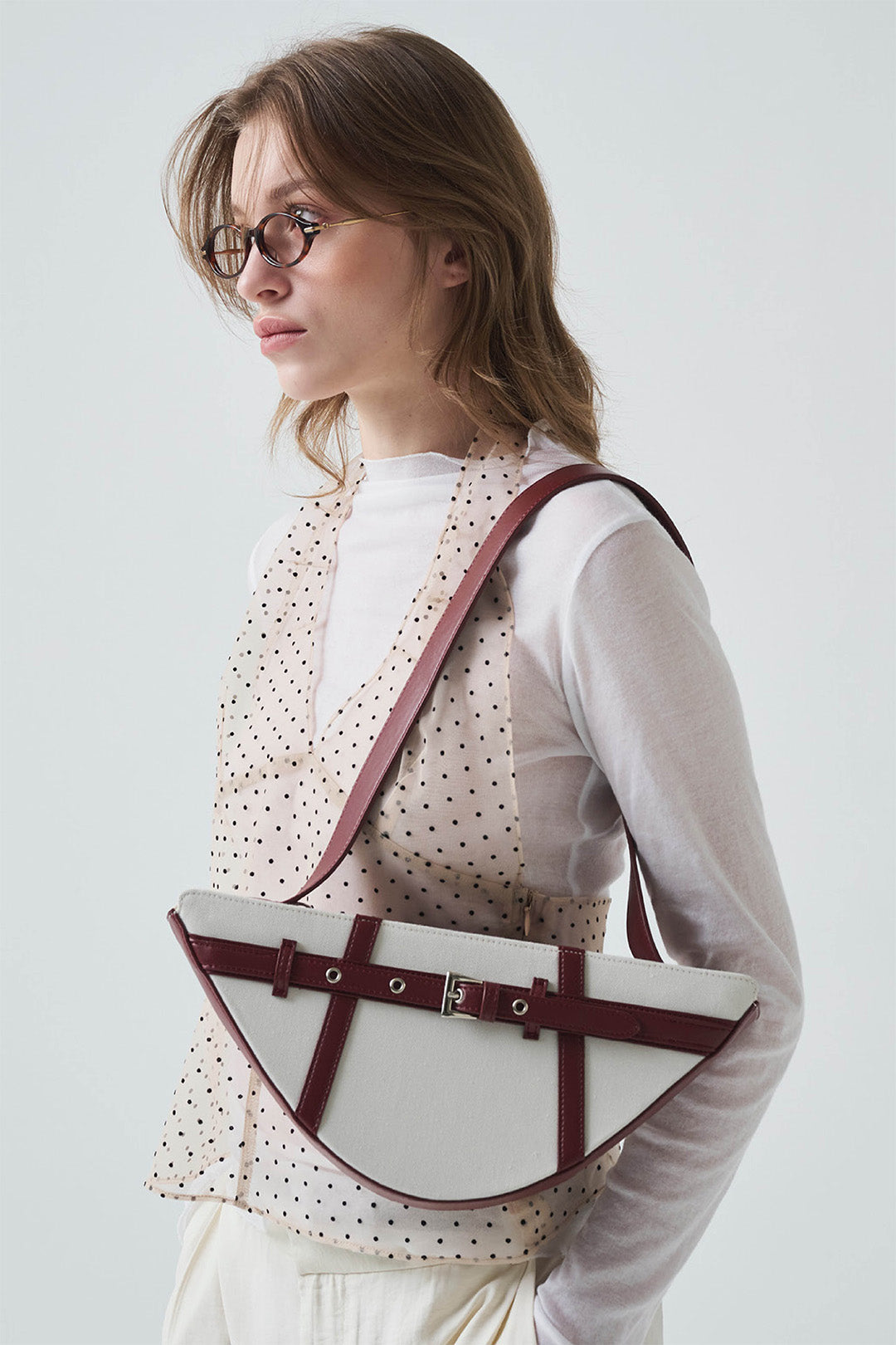 Deep red GOCHI Bag by LE SAUT showing a stylish, spacious leather handbag with sleek design and sturdy handles.