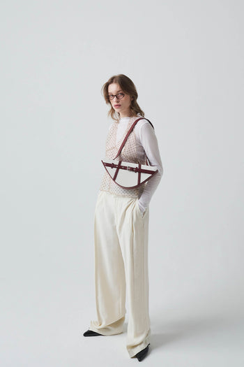 Deep red LE SAUT GOCHI bag with sleek design and sturdy handles, perfect for everyday use.