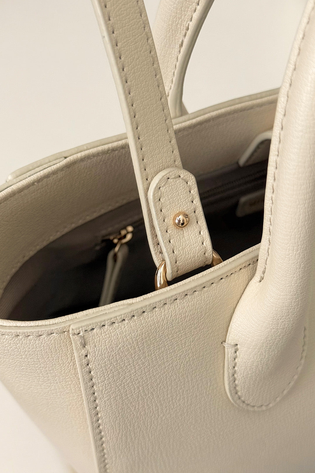 Medium Ivoire leather bag by MIULIN with structured silhouette and top handles, shown in a neutral ivory color.
