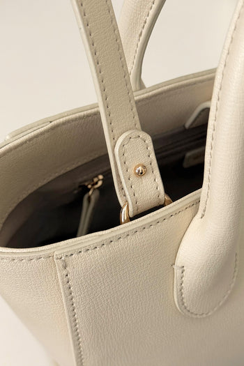 Medium Ivoire leather bag by MIULIN with structured silhouette and top handles, shown in a neutral ivory color.