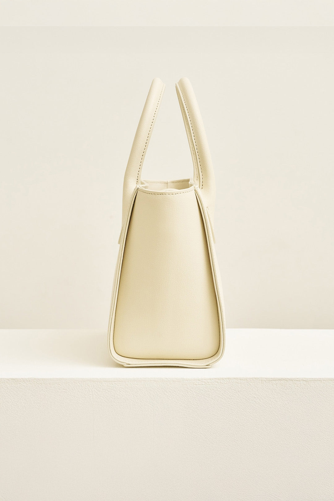 Medium Ivoire leather tote bag by MIULIN with sleek design and sturdy handles, perfect for everyday use.